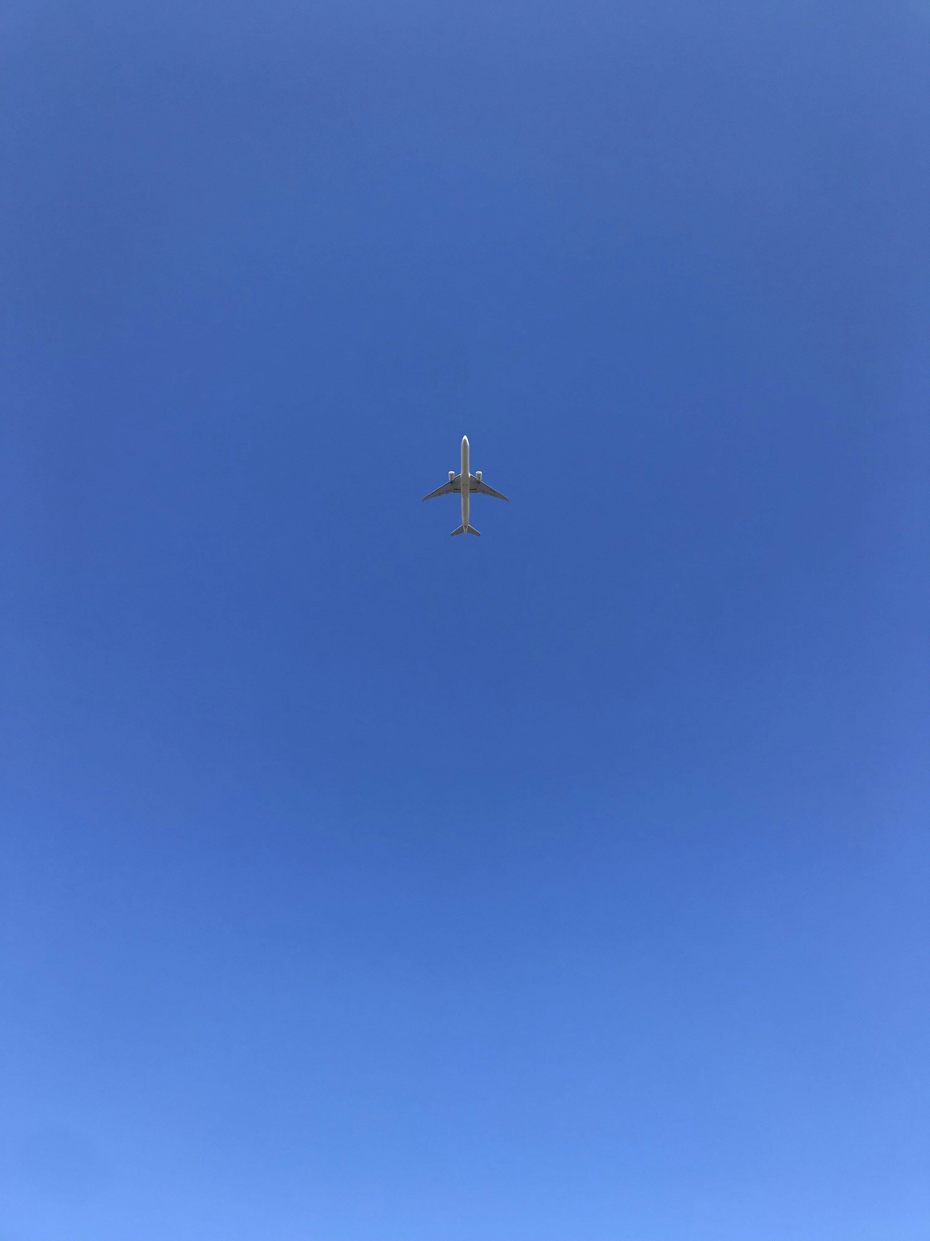 gray airplane flying during daytime